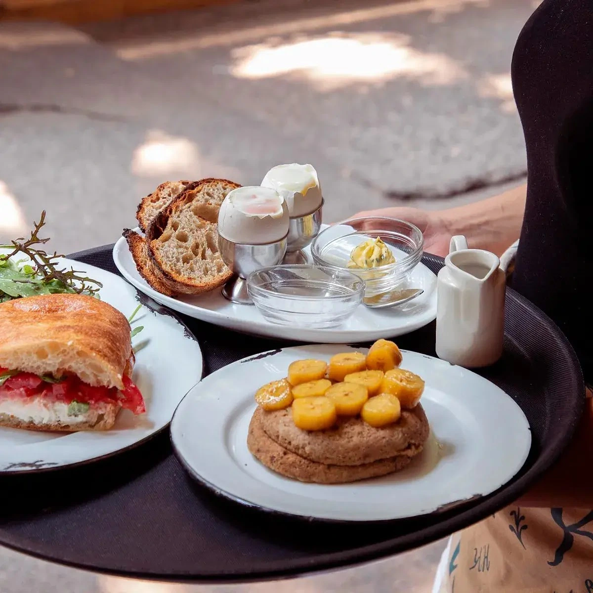 Colima breakfast tray with bread, eggs, and Rosetta Bakery pastries